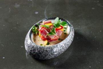 tuna tartare with tomato lemon onion chili and fresh herbs in a crockery