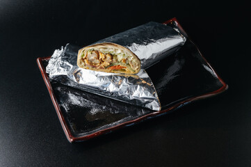 fresh hot lavash shawarma with meat, wrapped in foil