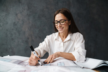 Smiling mid aged business woman in white shirt