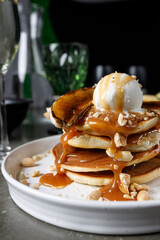 Pancakes with banana, caramel and ice cream scoop