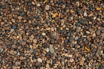 Closeup top view Pile of orange tans river stone or creek rock and beach rock texture background...