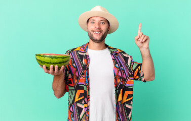 handsome traveler man feeling like a happy and excited genius after realizing an idea and holding a...