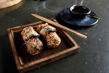 Spring rolls with salmon, shrimp and eel