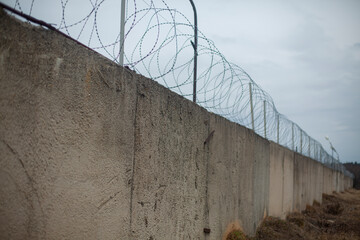 Fence with barbed wire. Fencing around the territory.