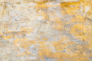 Background with an old concrete wall with an orange cracked paint
