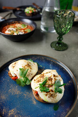 Eggs Benedict with lamb and tomato salsa