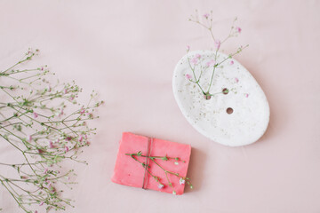 Natural handmade soap bar with ceramic soap dish and flowers, spa organic soap, sustainable lifestyle