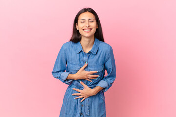 hispanic pretty woman laughing out loud at some hilarious joke