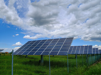 solar panels on a field across the dramatic sky. Solar energy industry. Alternative energy	
