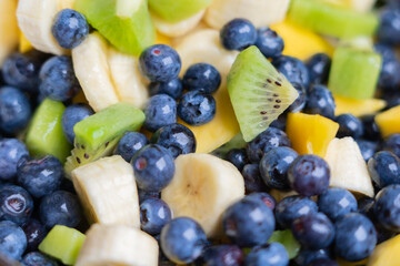 Fruit salad with fresh blueberries, bananas, kiwi and mango