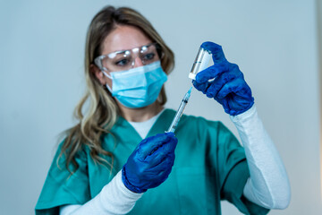 Female doctor or nurse holding COVID-19 Vaccine. Coronavirus medical treatment.