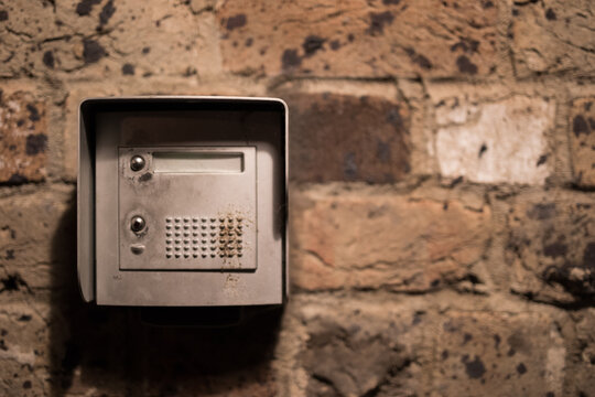 intercom switch doorbell brick wall - Powered by Adobe