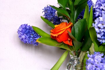 Spring flowers in a glass decanter.
