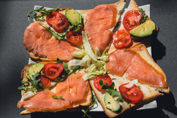 grilled salmon with vegetables and avocado on bread