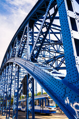 The oldest steel, arc, rivered, painted blue, bridge over the Vistula River in Krakow, Poland. Jozef Pilsudski bridge called 
