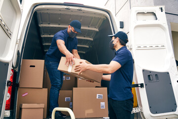 Bottom view of couriers unloading packages during a pandemic