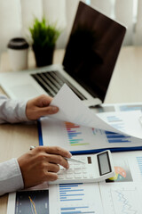 Financial Businessman analyze the graph of the company's performance to create profits and growth,...