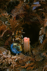 Burning candle, symbolic moon on  autumn leaves natural background. old pagan, Wiccan, Slavic...