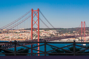 View from Almada of suspension  Ponte 25 de Abril bridge (The 25th April Bridge) over river Tejo in Lisbon, Portugal. Bridge alike Golden gate in Portugal. 