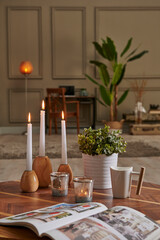 White candle and coffee style on the wood table, decorative working desk background with lamp concept.