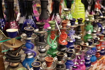 Many multicolored hookahs standing on counter of store