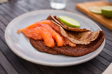 salted salmon fillet with rye pancakes and lime