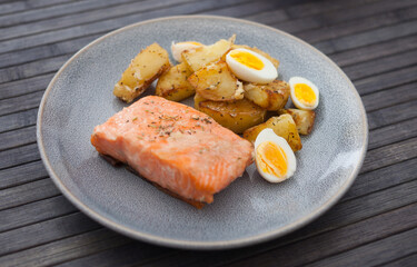steamed salmon fillet with potato wedges and quail egg