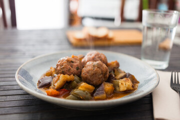 cooked meatballs with stewed eggplant with haze in bowl