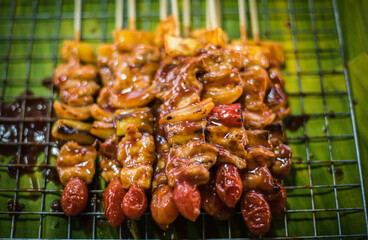 Barbecue pork skewers for sale on carts in Naklua Market, Thailand.