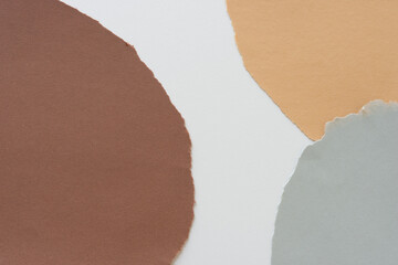 brown ochre yellow and light grey torn paper composition arranged with negative white space
