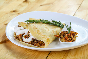 Pancake with minced meat and sauce