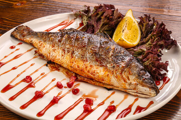 Grilled sea bass served lemon