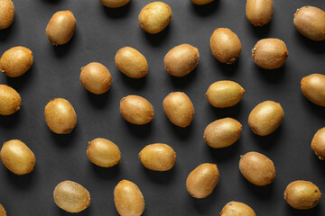 Many ripe kiwi on dark background