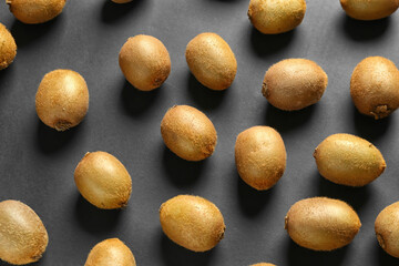 Many ripe kiwi on dark background