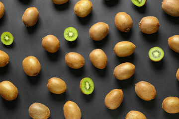 Many ripe kiwi on dark background