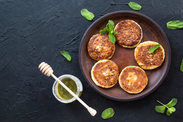 A healthy breakfast of cheese pancakes and honey. Creative atmospheric decoration