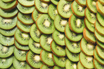 Many cut kiwi as background