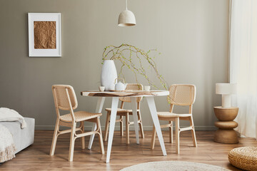 Stylish interior of dining room at cozy home with white mock up poster frame, design chairs, family...