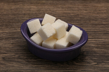 Refined white sugar cubs in the bowl