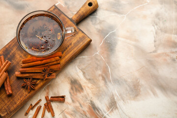 Cup of hot tea with cinnamon on color background