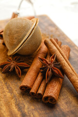 Tea strainer and aromatic cinnamon on table