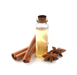Cinnamon sticks and oil on white background