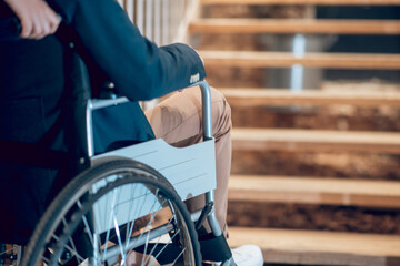 Man in wheelchair stopped near stairs