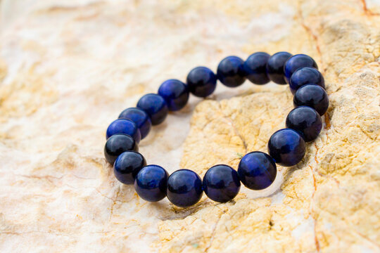 gemstone known as tiger eye or cat eye with a blue color contrasted with blue. , Blue Color Tigers Eye Stone