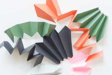 abstract construction paper zig-zags or fans isolated on white in black green orange and pink