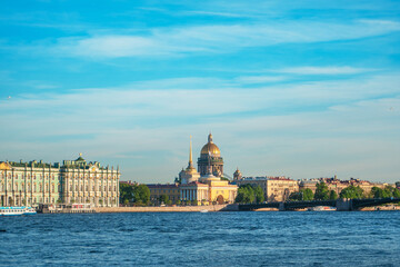 Fototapeta premium Beautiful view of St. Isaac's Cathedral from the Neva River embankment on a summer day, postcard view. Saint Petersburg, Russia - 05 Apr 2021