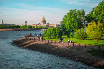 Beautiful view of St. Isaac's Cathedral from the Neva River embankment on a summer day, postcard...