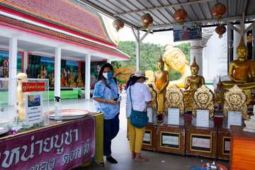 Buddha statue of Wat Khao Sung Chaem Fa temple on Khao Sam Sip Hap mountain for thai people and...