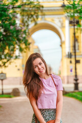 Fototapeta na wymiar Cute tourist woman in St. Petersburg on the background of a yellow arch with beautiful architecture, tourist summer season