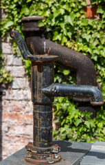 Fototapeta na wymiar Vintage water pump in the park